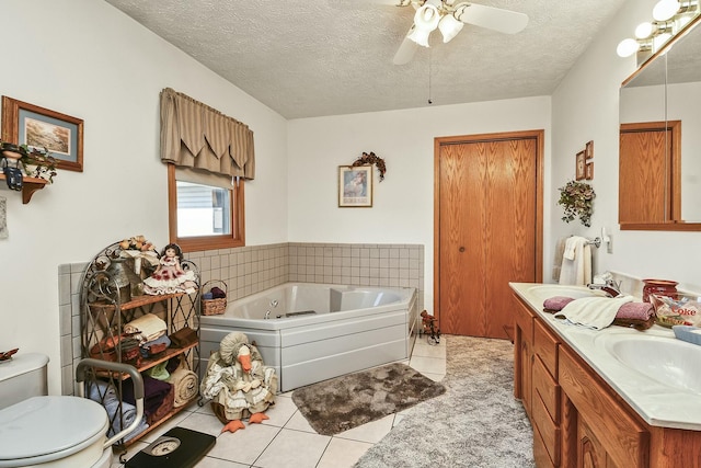 full bathroom with a whirlpool tub, a textured ceiling, vanity, and tile patterned floors