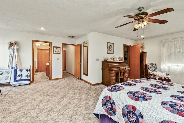 carpeted bedroom featuring a textured ceiling, ceiling fan, visible vents, and baseboards