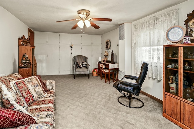 living area with carpet floors and a ceiling fan