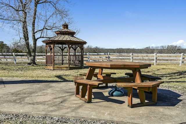 view of home's community with a patio area, fence, and a gazebo