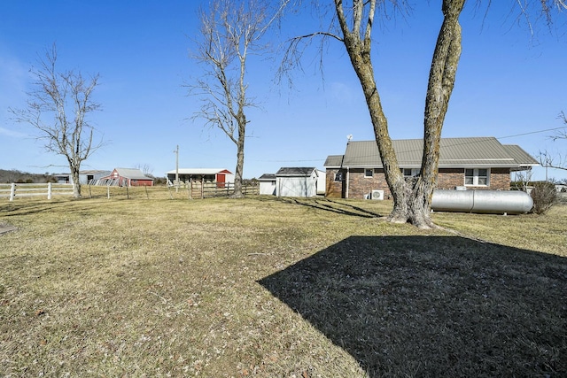 view of yard featuring fence and an outdoor structure