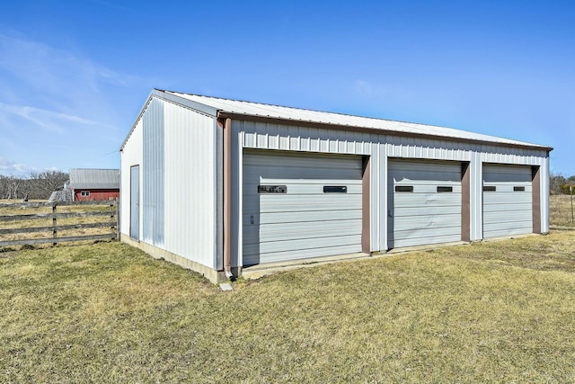 detached garage featuring fence