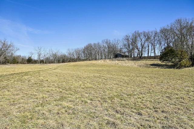 view of yard featuring an outbuilding and a rural view