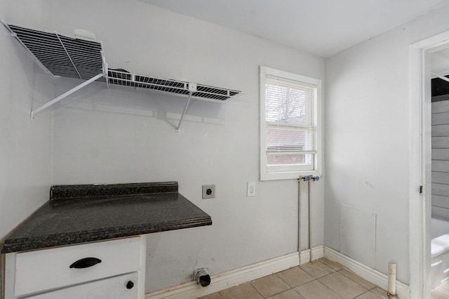 washroom with laundry area, light tile patterned floors, baseboards, and electric dryer hookup