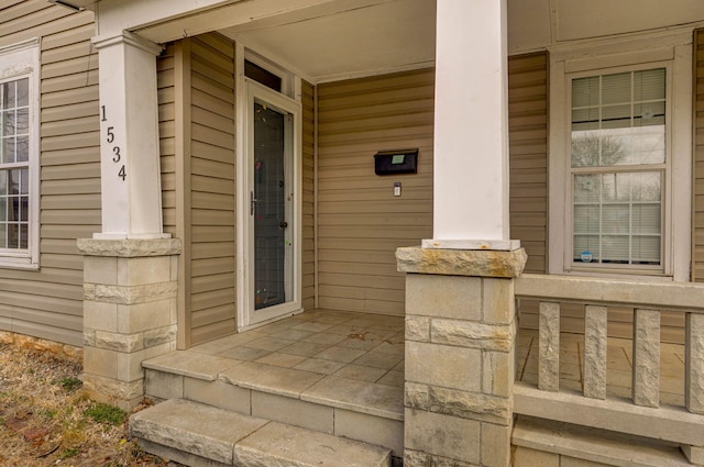 view of exterior entry featuring a porch