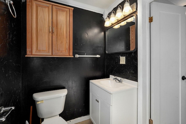 half bathroom with toilet, ornamental molding, and vanity