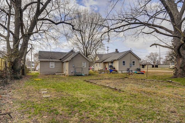 back of house with a lawn