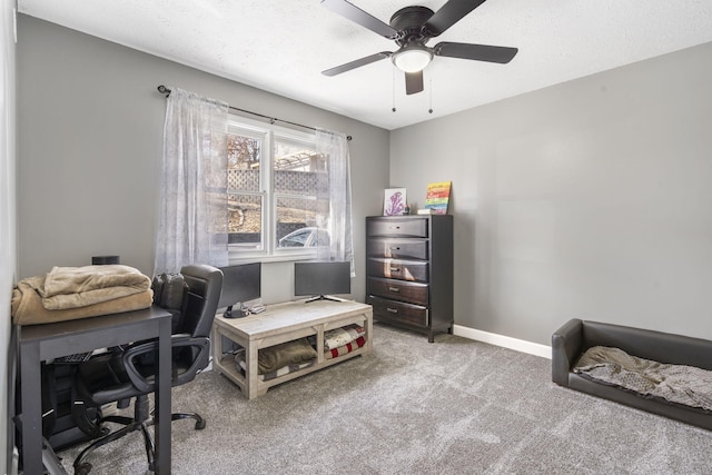 office space featuring ceiling fan, carpet floors, a textured ceiling, and baseboards