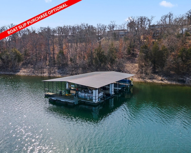 view of dock featuring a water view, boat lift, and a wooded view