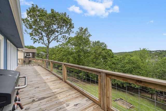 wooden deck featuring area for grilling, a yard, and outdoor dining area
