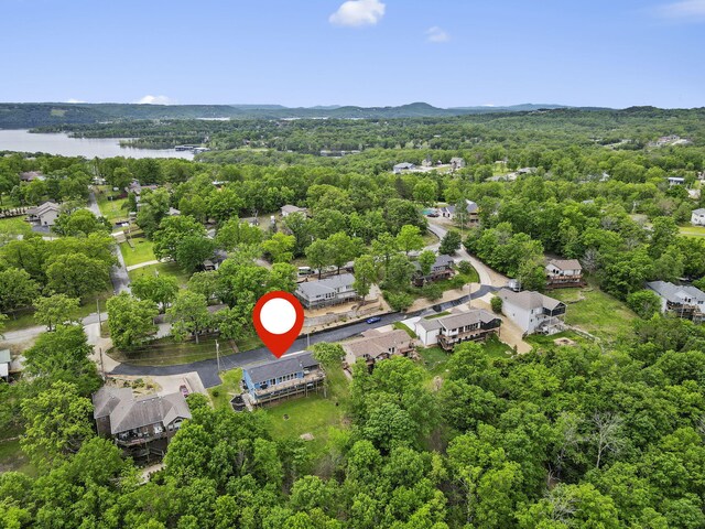 drone / aerial view featuring a forest view and a water and mountain view