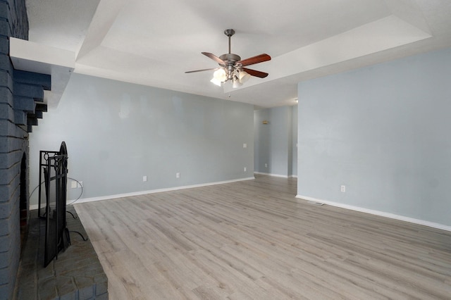 unfurnished living room with visible vents, ceiling fan, baseboards, and wood finished floors