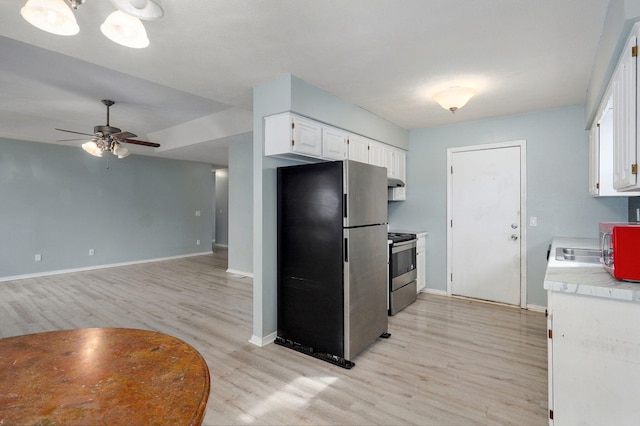 kitchen with baseboards, white cabinets, light countertops, appliances with stainless steel finishes, and light wood-type flooring