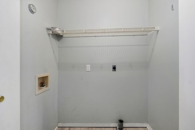 washroom featuring washer hookup, electric dryer hookup, wood finished floors, laundry area, and baseboards