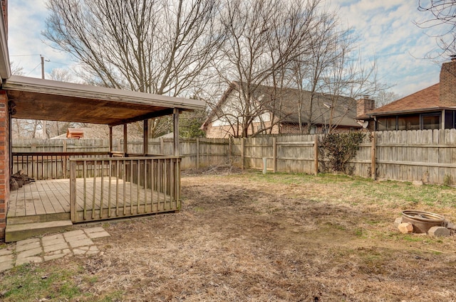 view of yard with a fenced backyard and a wooden deck