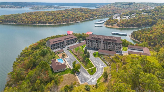 aerial view featuring a water view and a wooded view