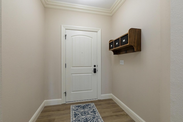 entryway with baseboards, wood finished floors, and crown molding