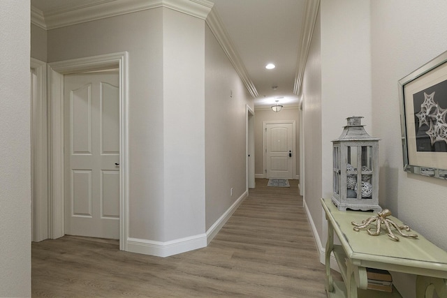 hallway with baseboards, ornamental molding, wood finished floors, and recessed lighting