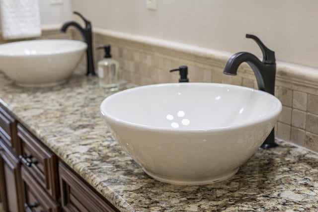 room details featuring a wainscoted wall and vanity