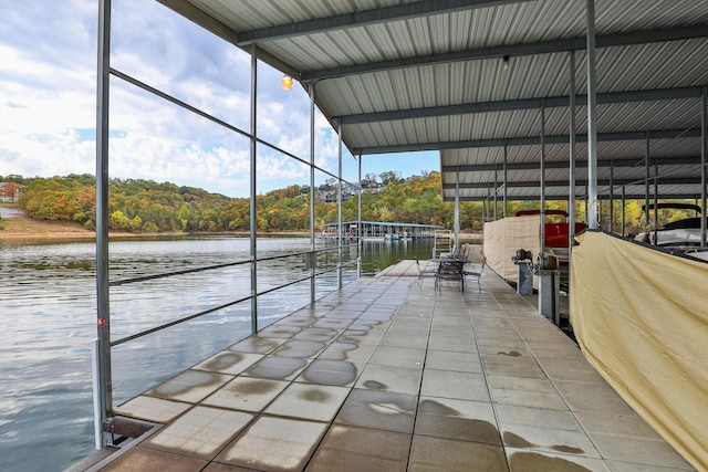 view of patio / terrace featuring a water view and a boat dock