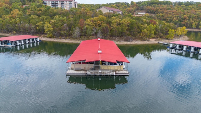 view of dock featuring a water view and a wooded view