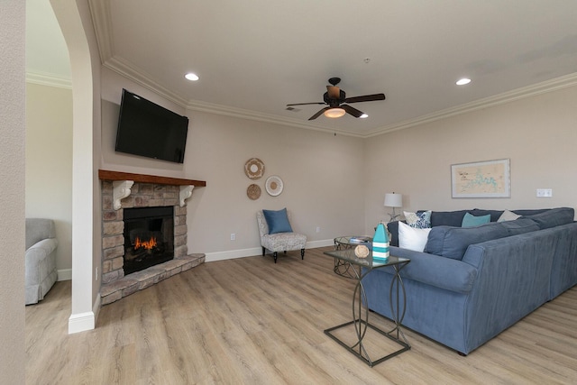 living room with baseboards, light wood finished floors, and crown molding