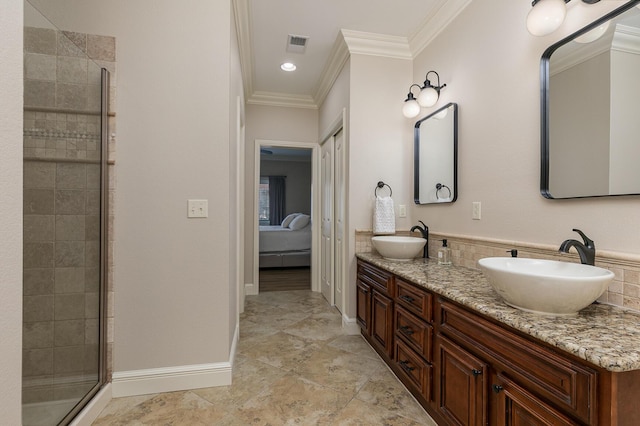 bathroom with crown molding, a stall shower, visible vents, and a sink