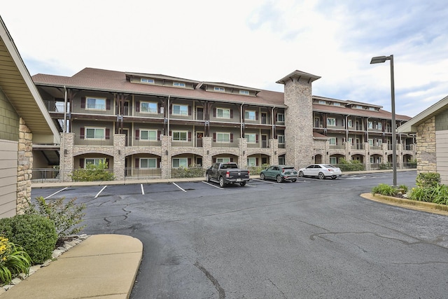 view of building exterior featuring uncovered parking