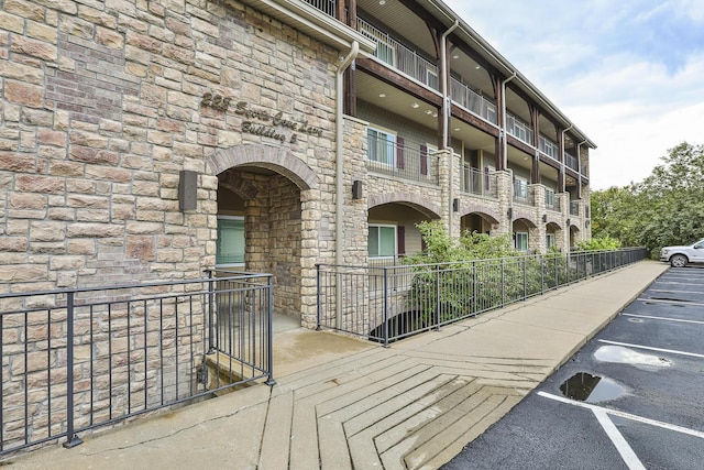 view of building exterior featuring uncovered parking