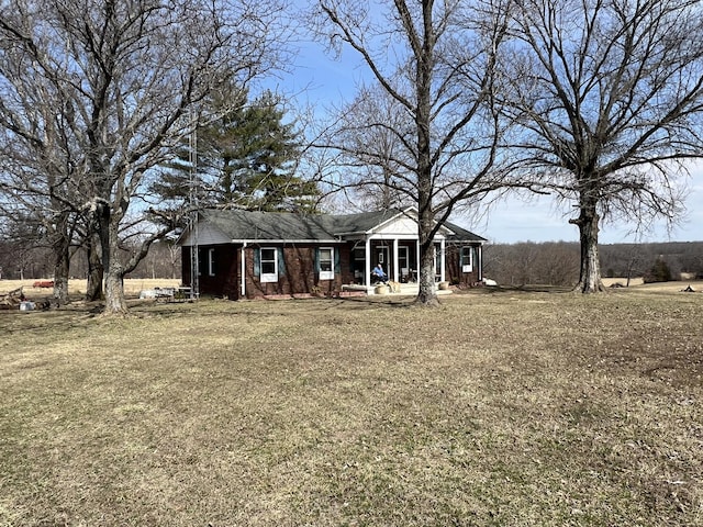 view of front of property featuring brick siding and a front yard