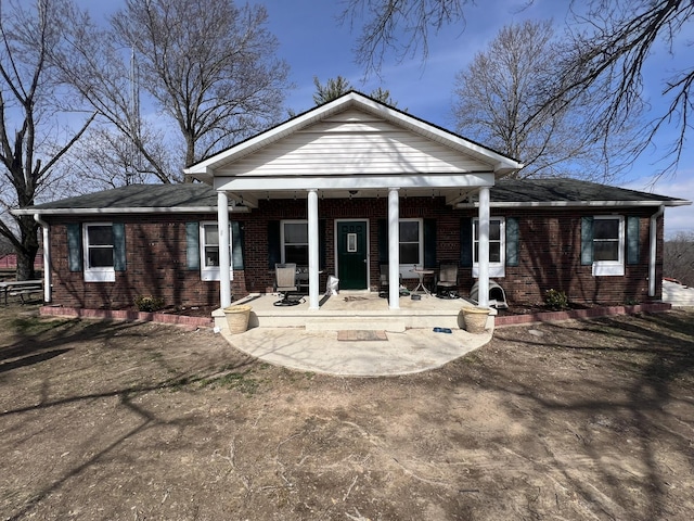 rear view of house with a patio area and brick siding