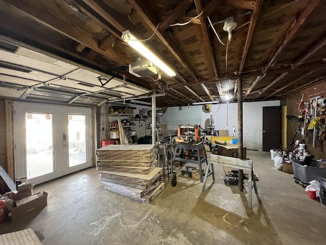 basement with french doors and a workshop area