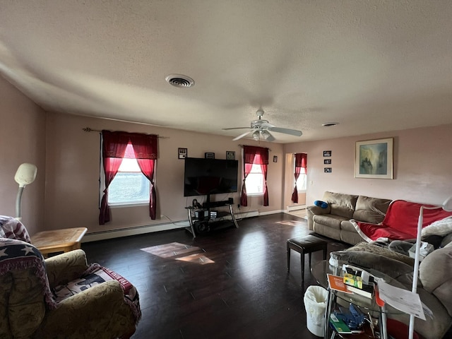 living room with baseboards, visible vents, a ceiling fan, wood finished floors, and a textured ceiling