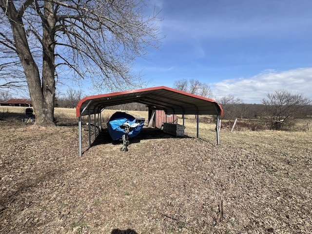 view of parking with driveway and a carport