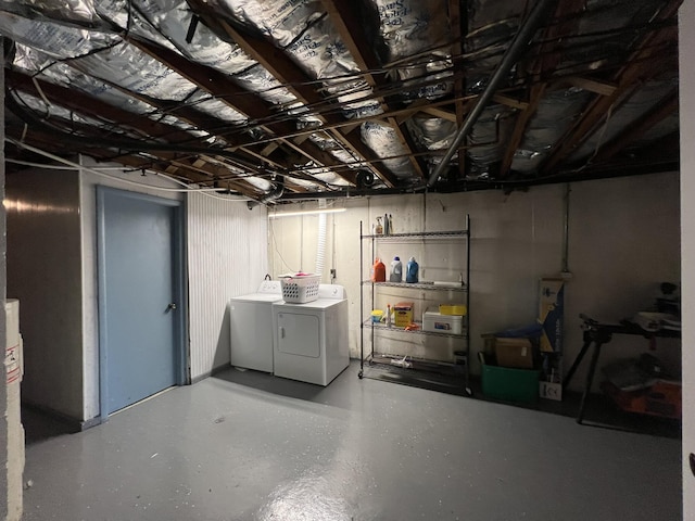 unfinished basement featuring washing machine and clothes dryer