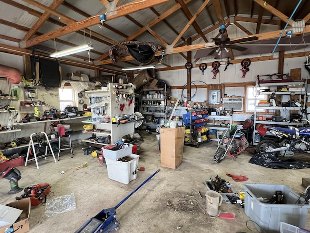 garage with ceiling fan and a workshop area