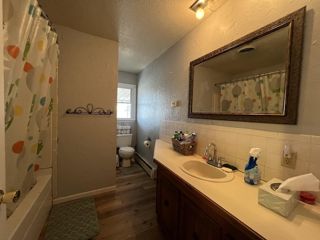 full bathroom with a textured wall, toilet, wood finished floors, a textured ceiling, and a baseboard heating unit