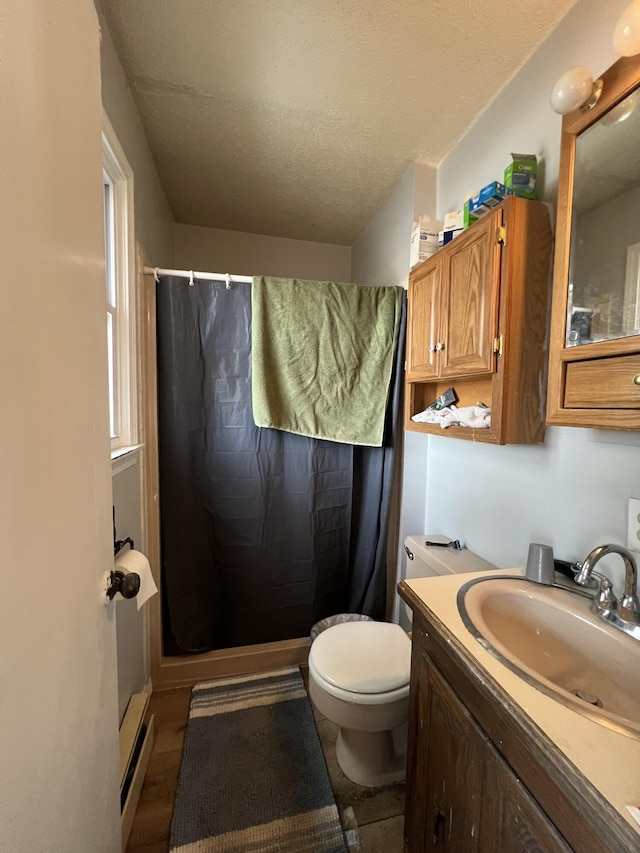 bathroom with toilet, a shower stall, a textured ceiling, and vanity