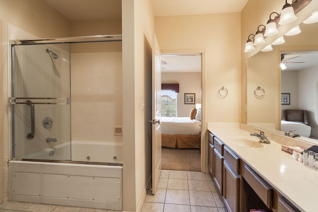 bathroom with ensuite bathroom, enclosed tub / shower combo, ceiling fan, vanity, and tile patterned flooring