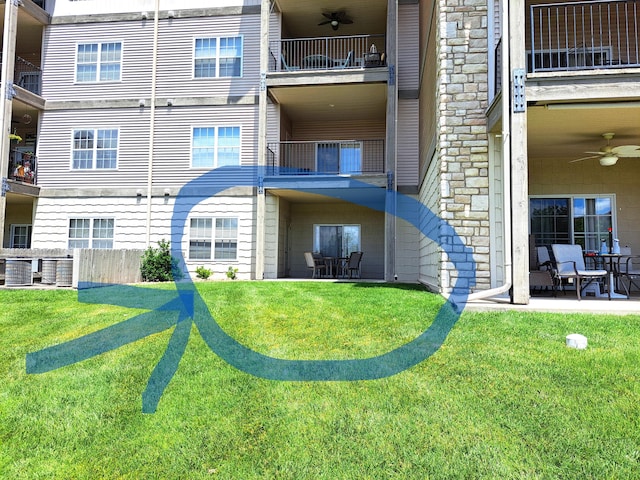 back of house featuring a patio area, ceiling fan, and a lawn