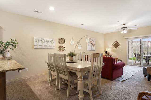 dining area featuring a ceiling fan, carpet flooring, visible vents, and baseboards