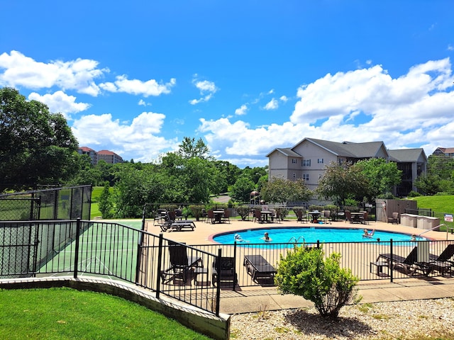 community pool featuring a patio area and fence