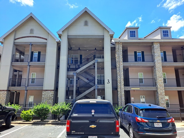 view of building exterior with uncovered parking