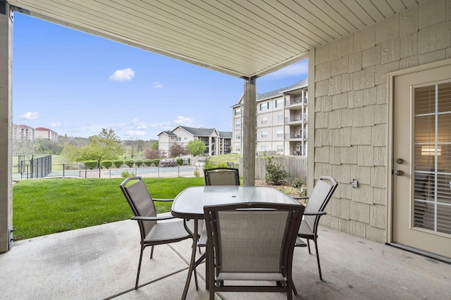 view of patio / terrace with outdoor dining space and fence