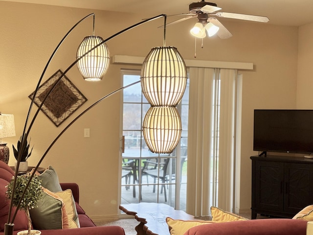 carpeted living area featuring a ceiling fan