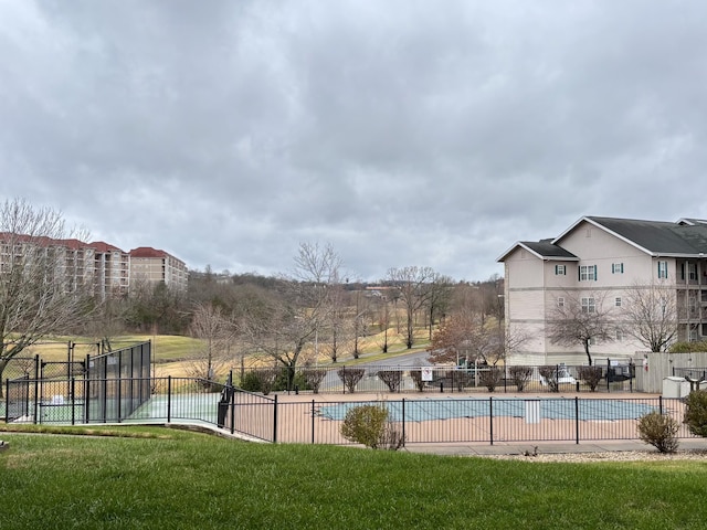 pool featuring fence, a lawn, and a patio