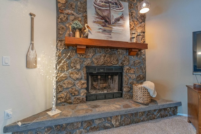 room details with carpet floors and a stone fireplace