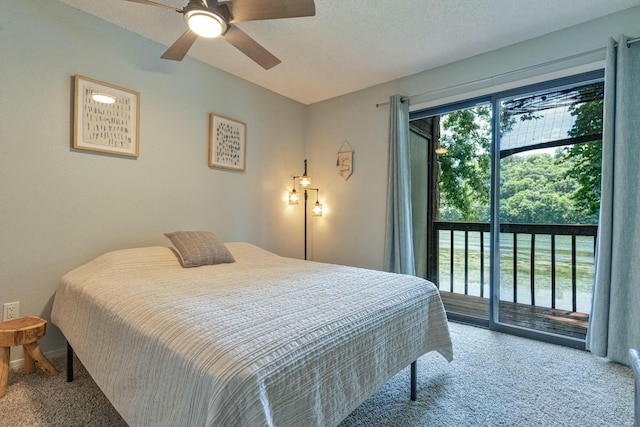 carpeted bedroom featuring access to exterior, a textured ceiling, and a ceiling fan