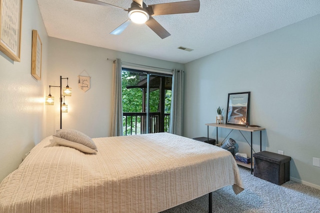 carpeted bedroom featuring a textured ceiling, ceiling fan, visible vents, and access to exterior