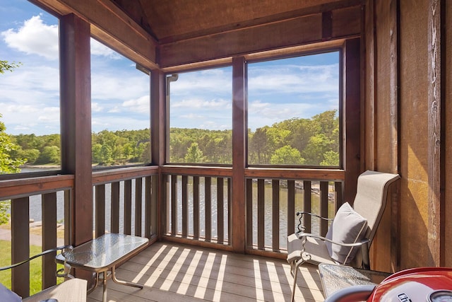 sunroom / solarium featuring a forest view